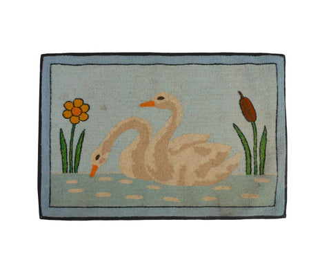 A Folk Art Hooked Mat of a Pair of Swans