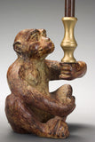 A Patinated Bronze Monkey Candleholder